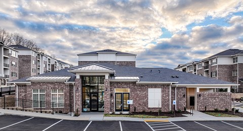 a brick building with a cloudy sky in the background