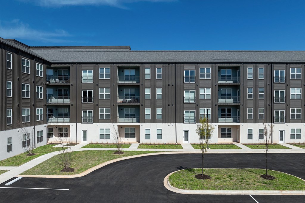 an apartment building with a roundabout in front of it