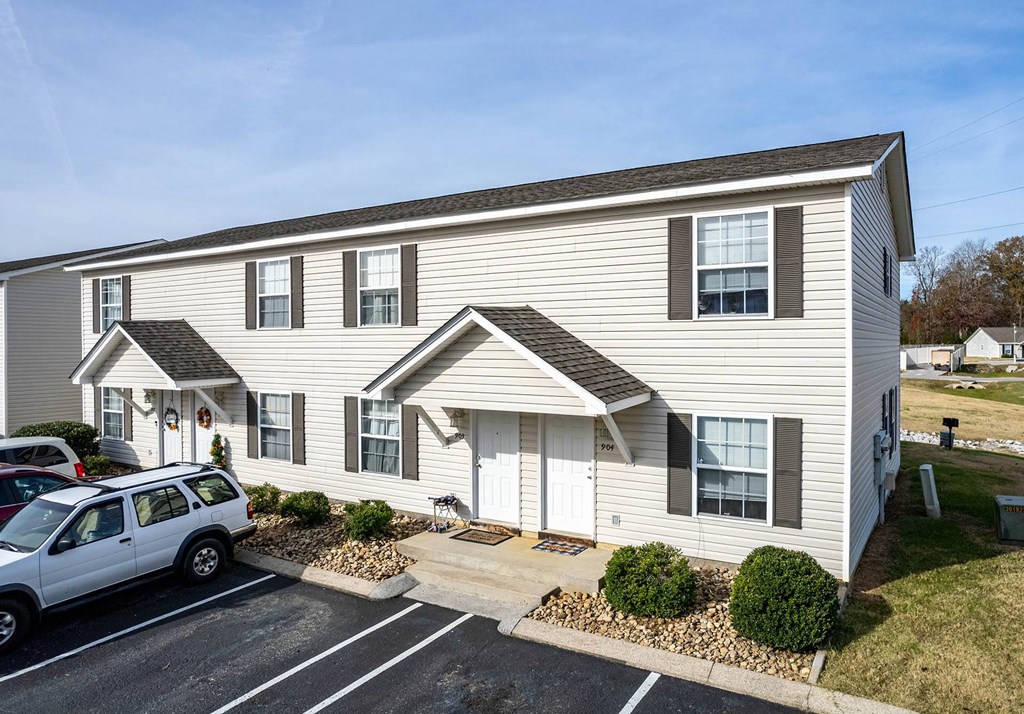 a large white building with a parking lot in front of it