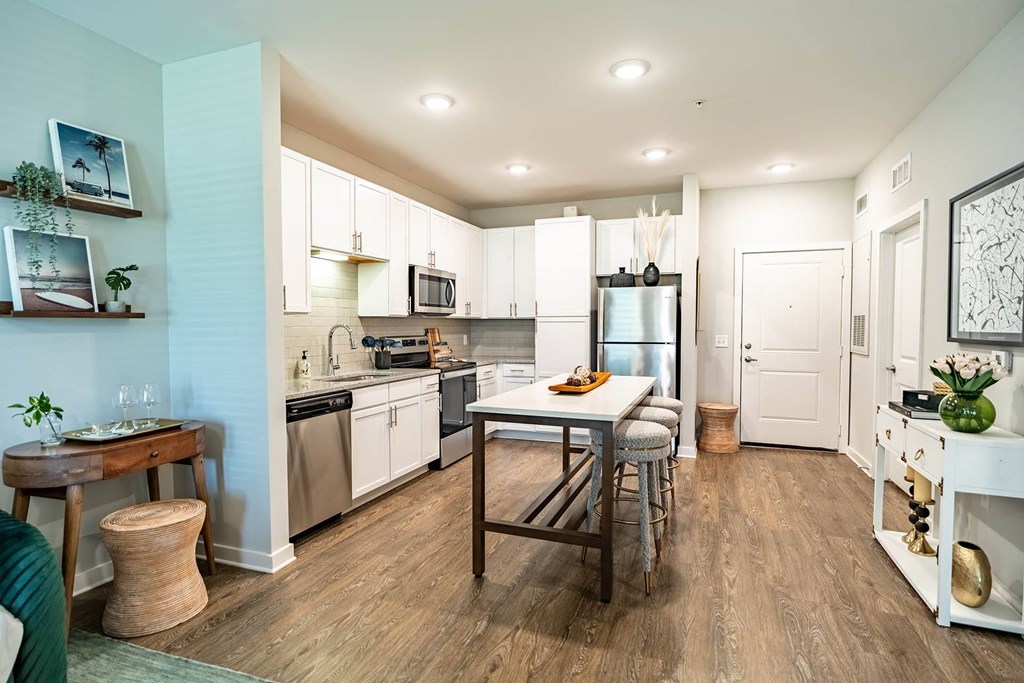 a kitchen with white cabinets and stainless steel appliances