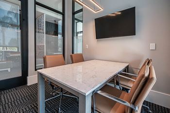 a conference room with a marble table and chairs at Altis Grand Suncoast, Land O' Lakes, 34638