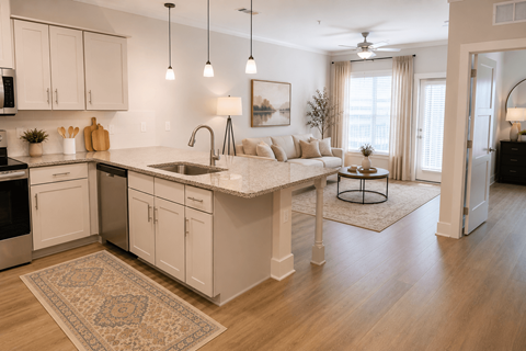 A kitchen with white cabinets and a rug on the floor.