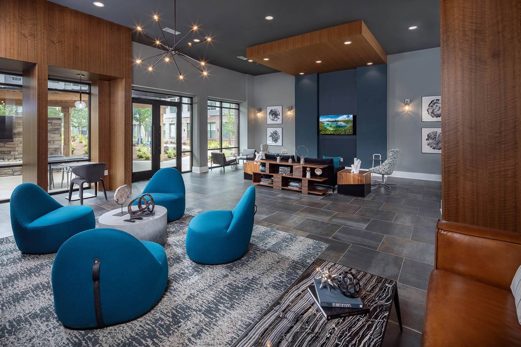 a living room with blue chairs and a couch