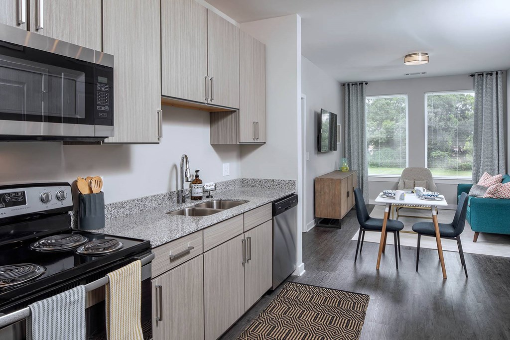 a kitchen and living room with a table and chairs
