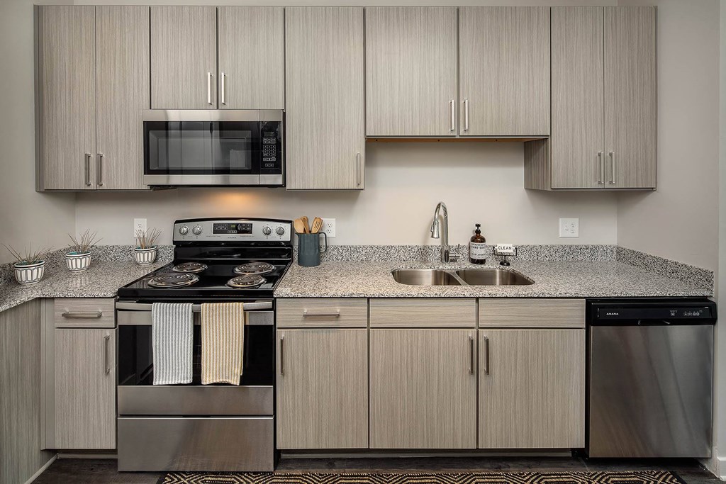 a kitchen with stainless steel appliances and granite counter tops
