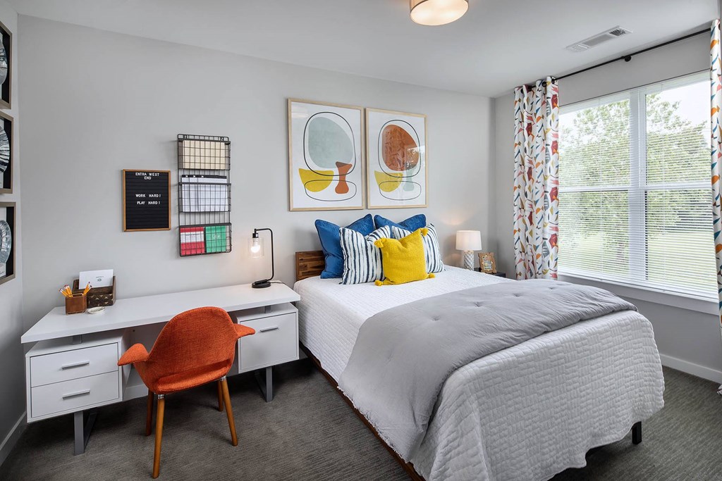 a bedroom with a bed and a desk