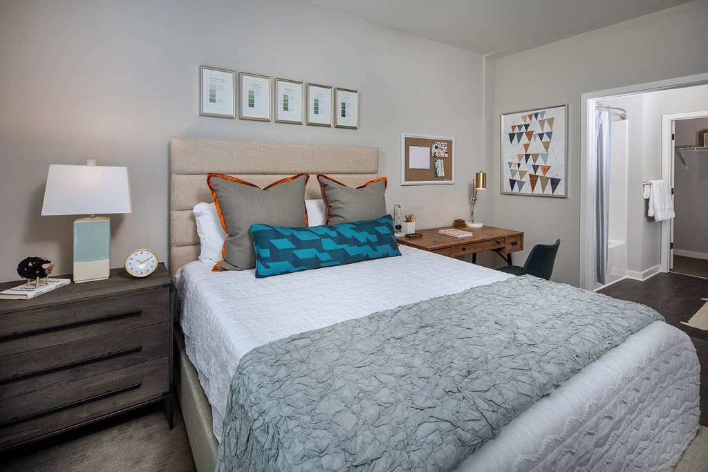 a bedroom with a bed and a desk