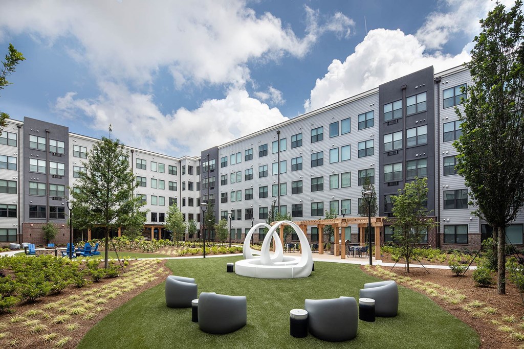 a courtyard with a white sculpture in the middle of an apartment building