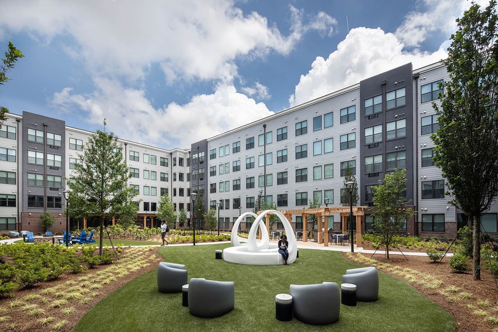a park with a fountain in the middle of a building