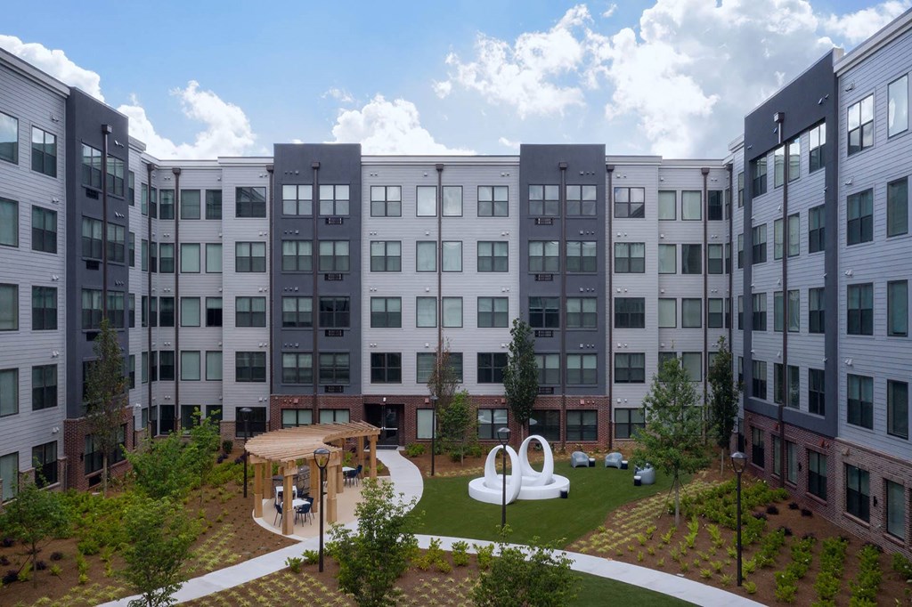 a rendering of an apartment building with a playground and a courtyard