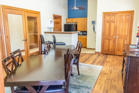 a dining room and kitchen with a large table and chairs