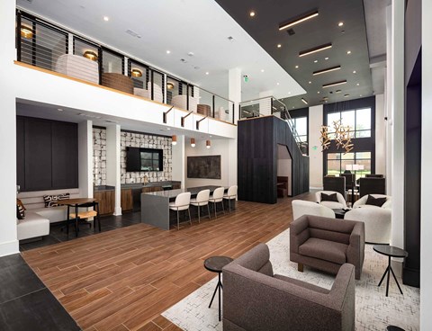 A modern living room with a wooden floor and furniture.