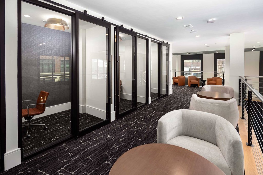 A modern office space with a long table and chairs.