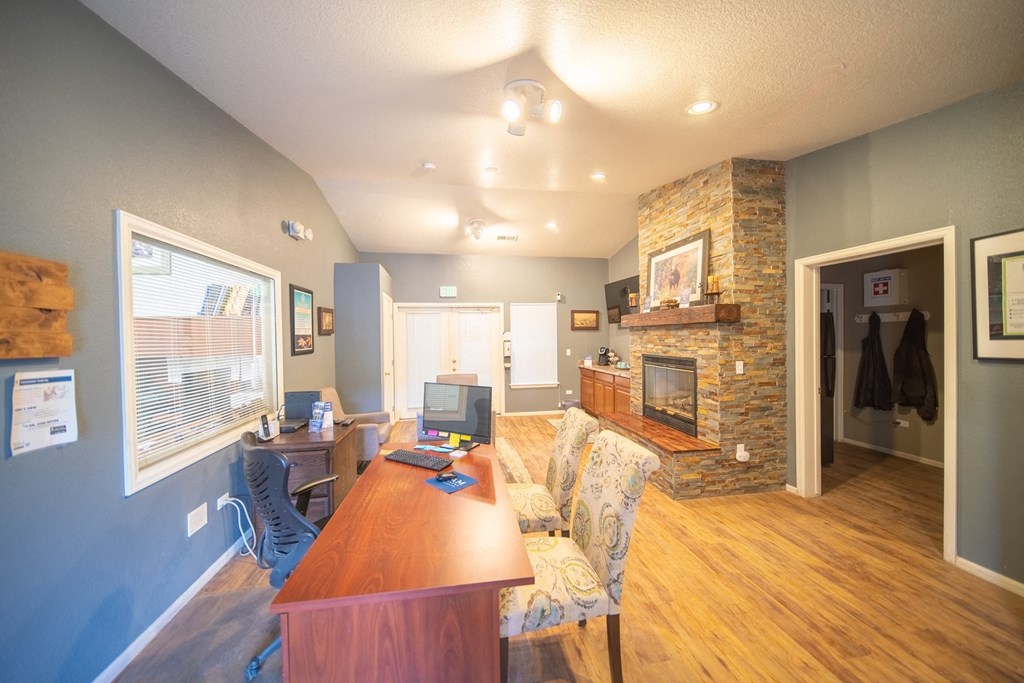 the view of a living room with a fireplace and a wooden table