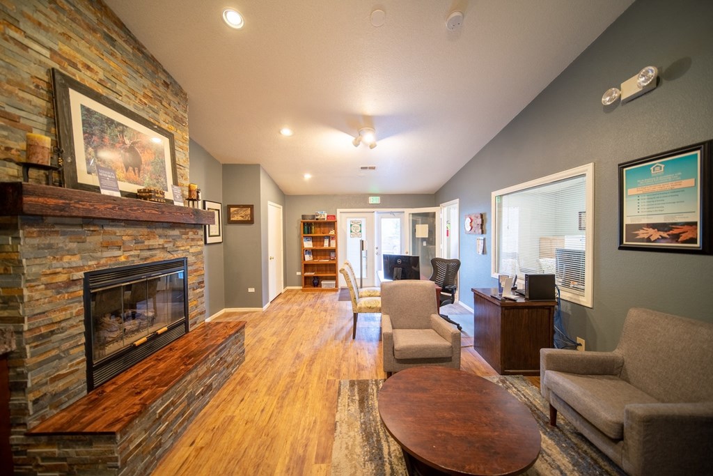 a living room with a fireplace and a table and chairs