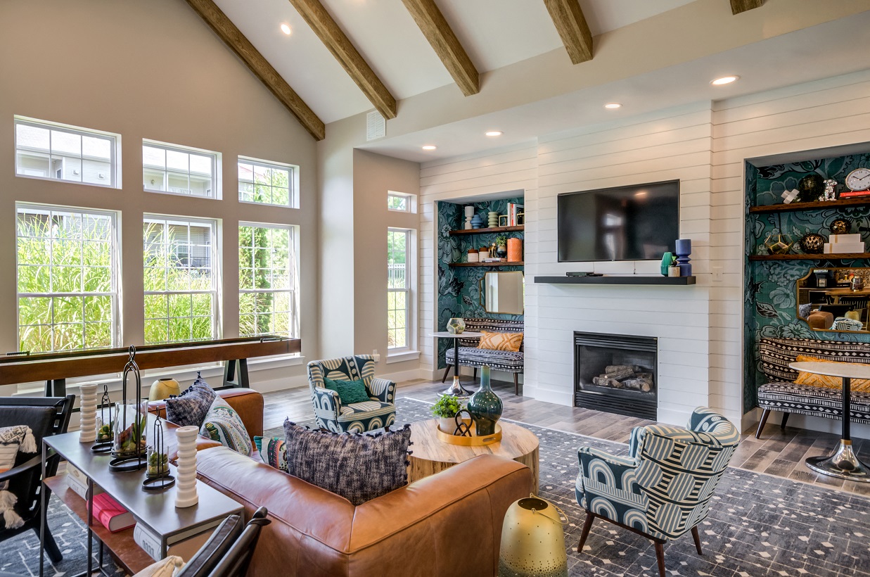 A living room with a fireplace and a television on the wall.