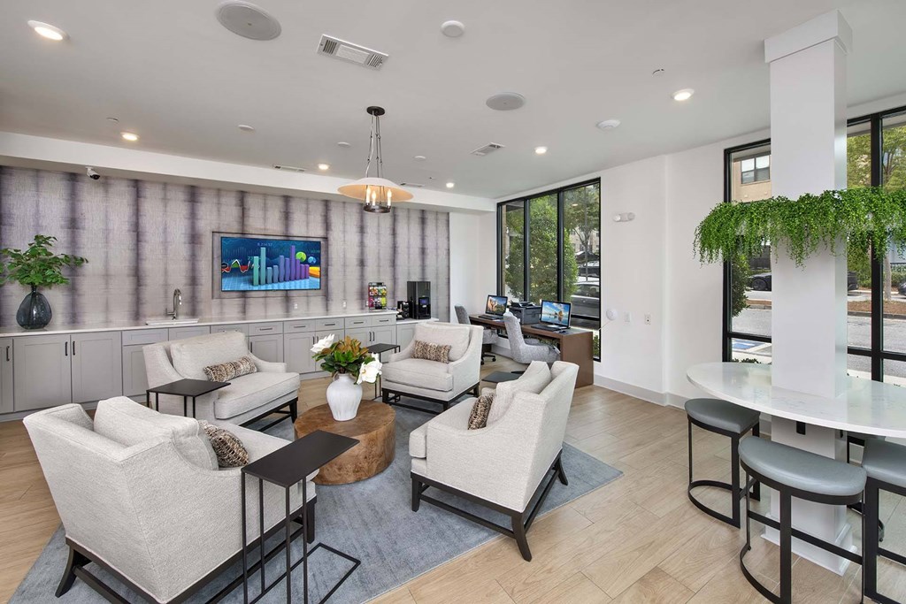 A modern living room with a large window and a flat screen TV mounted on the wall.