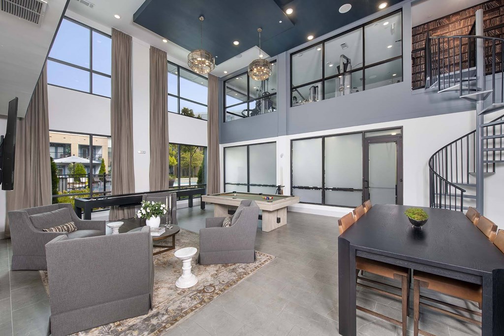 A modern living room with a spiral staircase and a dining area.