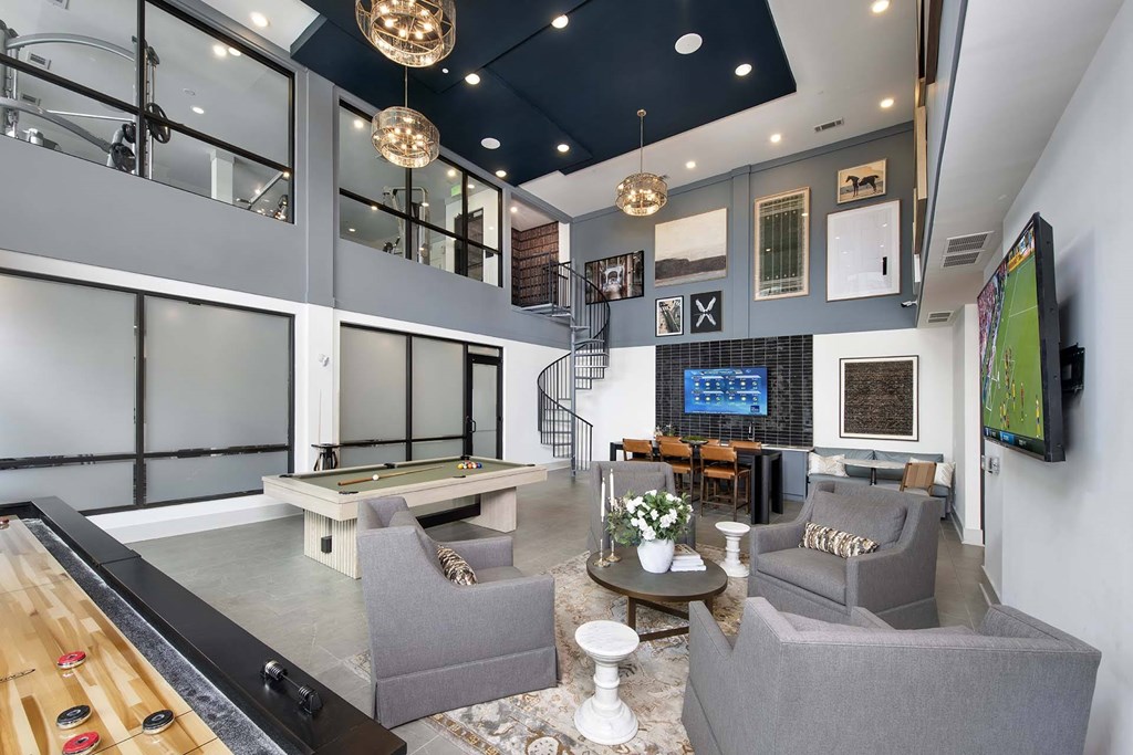 A spacious living room with a pool table and comfortable seating.