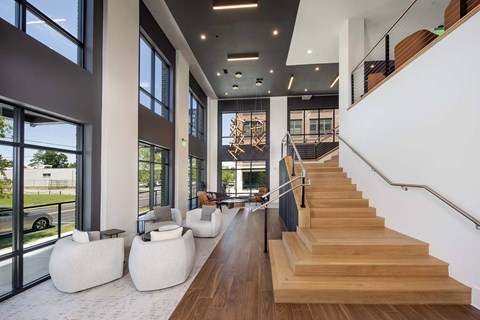 A staircase with a metal railing leads to an upper floor.