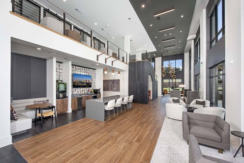 A modern living room with a long wooden floor and a white sofa.