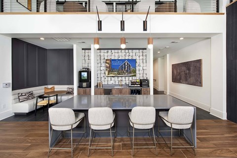 A modern kitchen with a dining table and chairs.