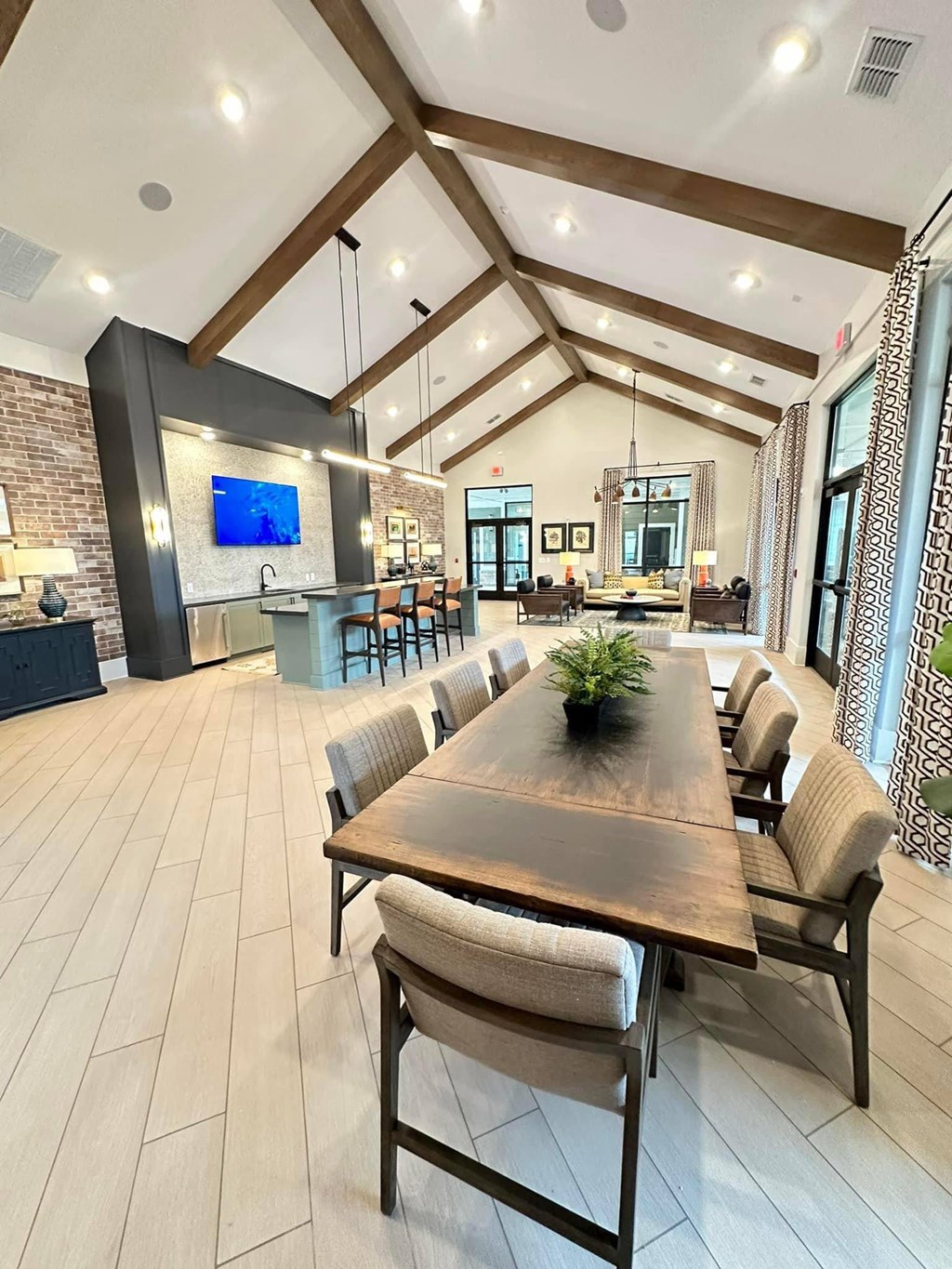 a large dining room with a wooden table and chairs