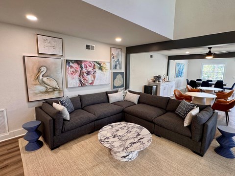 A living room with a grey couch and a coffee table.