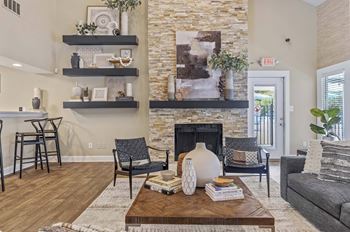 A living room with a fireplace and a stone wall.
