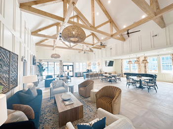 A large, open-plan living area with a piano and multiple seating options.