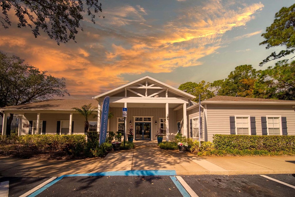 A building with a covered walkway and a blue banner on the left side.