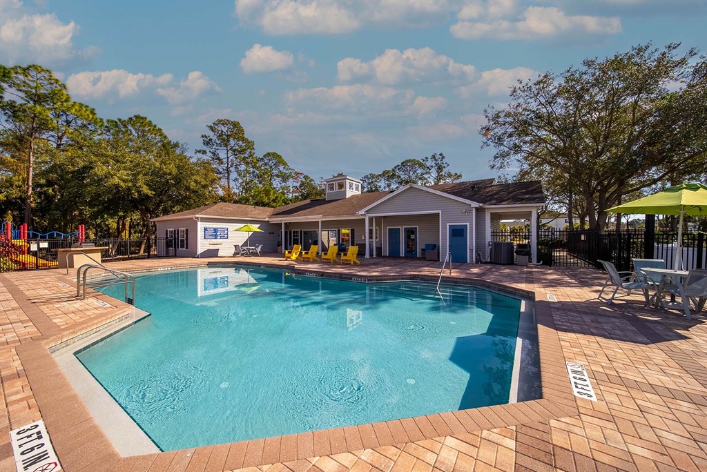 A swimming pool with a building in the background.