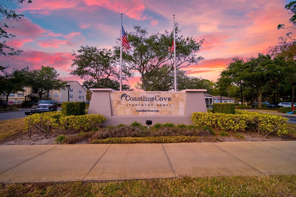 The entrance to Coastline Cove Estates is framed by a beautiful sunset.