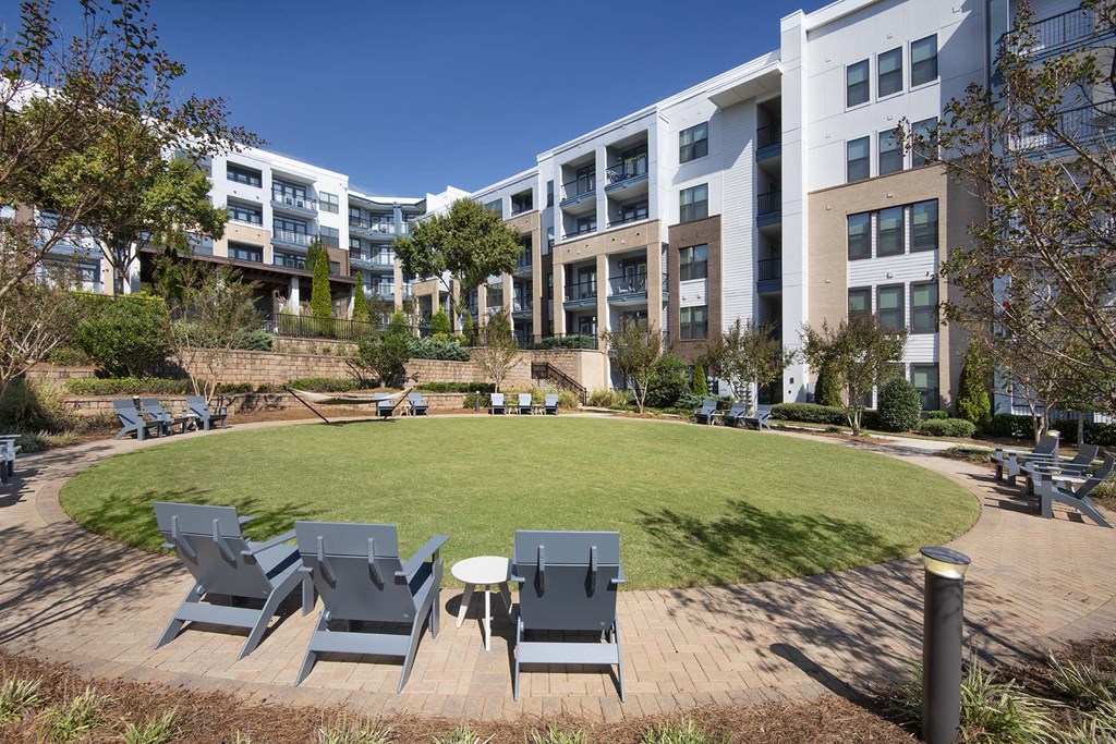 A large white building with a green lawn in front.