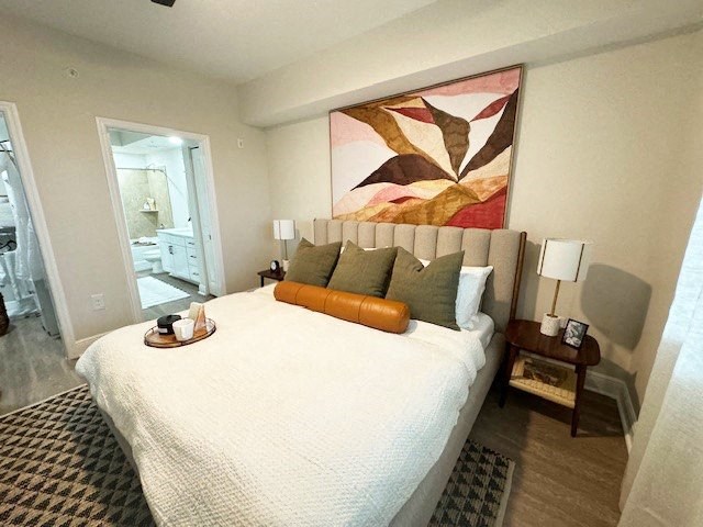 a bedroom with a large bed and a painting