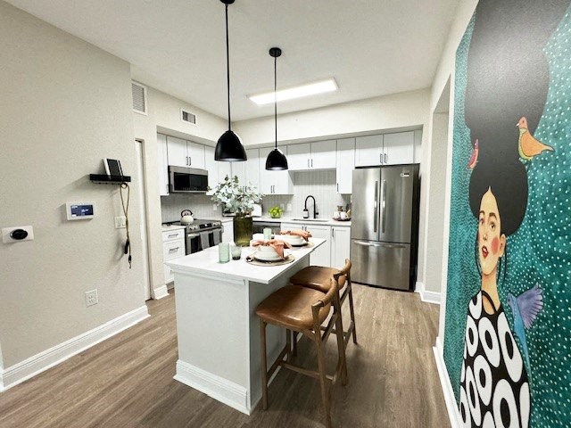 an open kitchen with a table and chairs