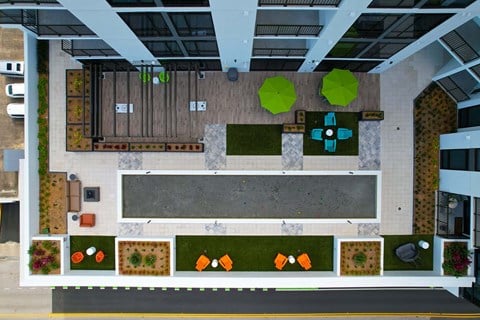 an overhead view of a living room with furniture and plants