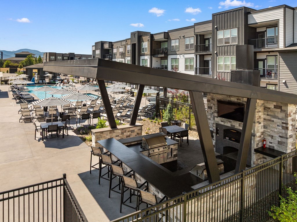 A large outdoor patio area with a pool and seating area.