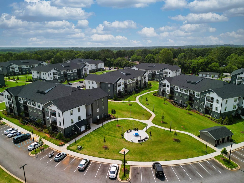 an aerial view of a large green field with rows of houses on top of it