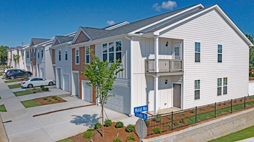 a row of townhomes with a car parked in front of them