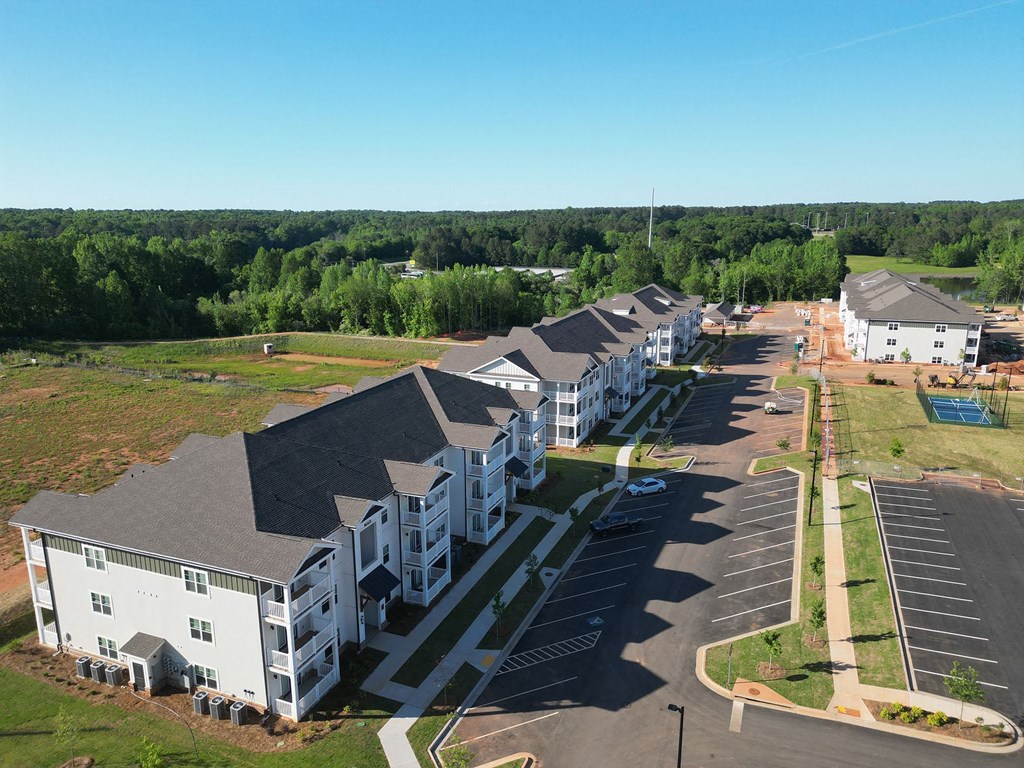 an aerial view of a row of apartment buildings in a parking lot