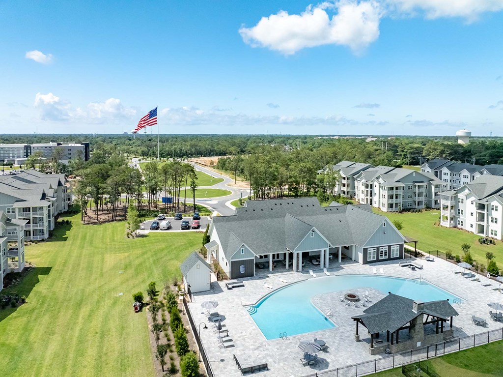 A large building with a pool in front of it.