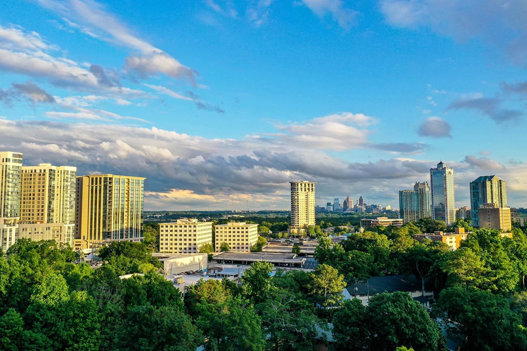 an aerial view of the philadelphia skyline with trees in the foreground
