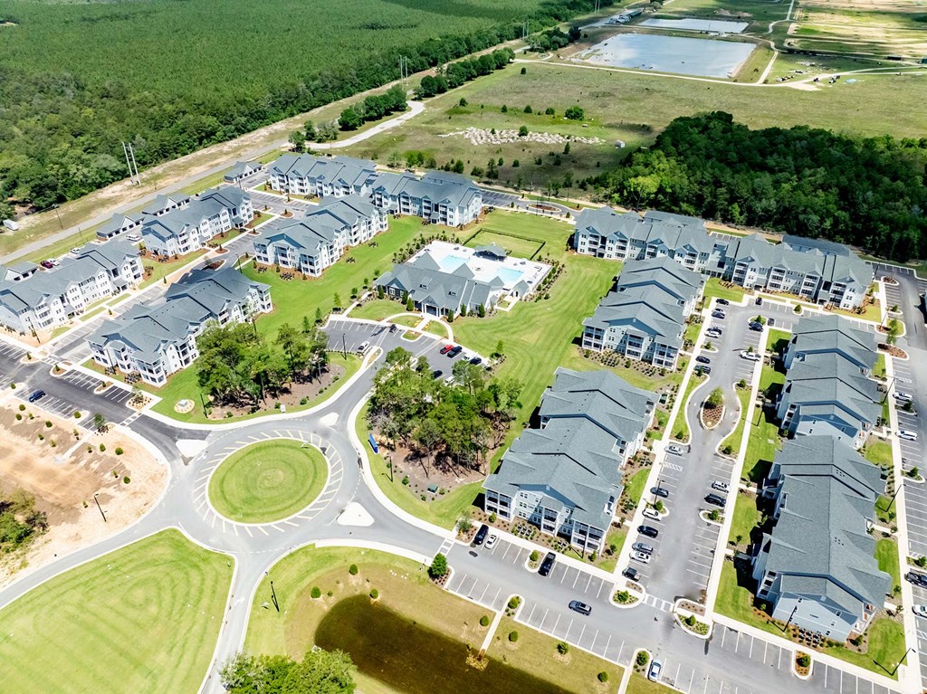 A large, roundabout is in the middle of a housing development.