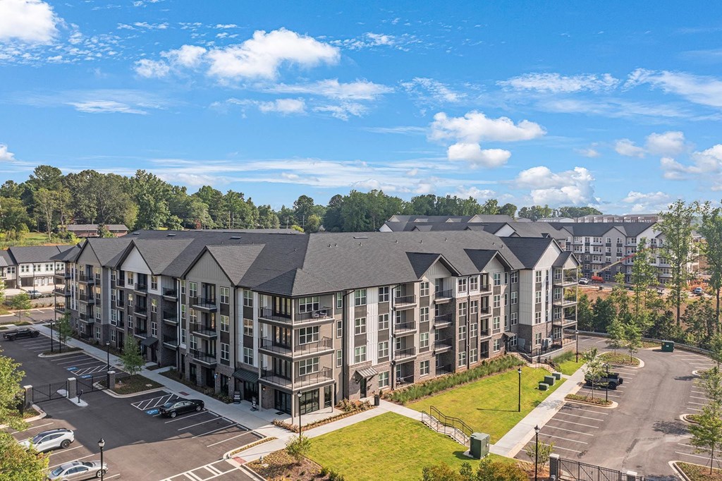 an aerial view of an apartment building on a sunny day