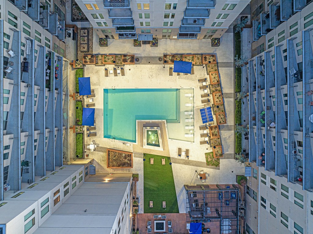 a birds eye view of a building with a pool in the middle