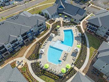 an overhead view of a swimming pool in an apartment complex