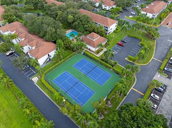 an aerial view of a tennis court and some houses