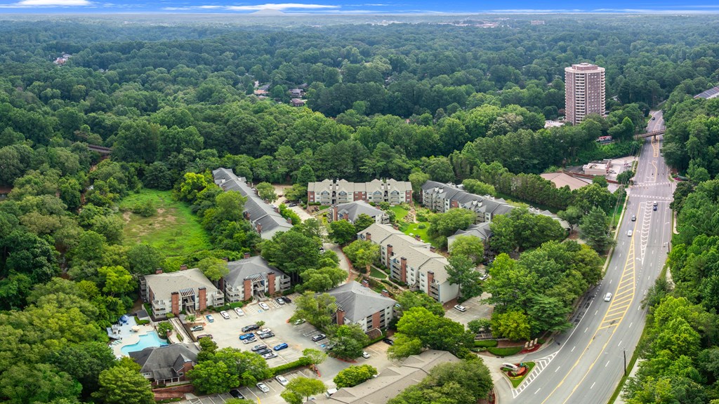 A bird's eye view of a residential area with a road running through it.
