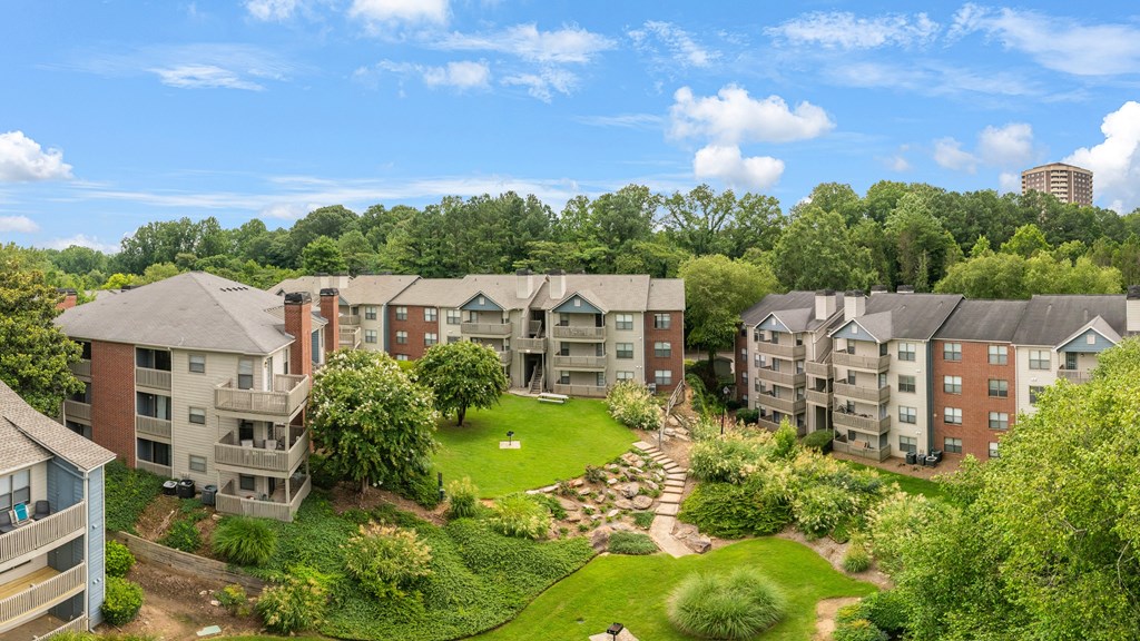 Apartment complex with a green lawn in the middle.